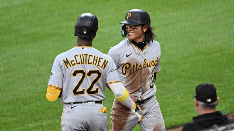 Pittsburgh Pirates Ji Hwan Bane, right, is congratulated by Andrew...