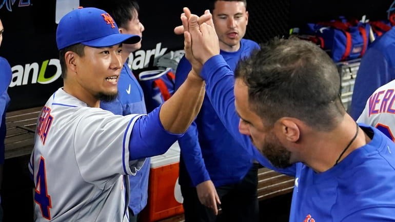 Mets starting pitcher Kodai Senga greets a team member before...