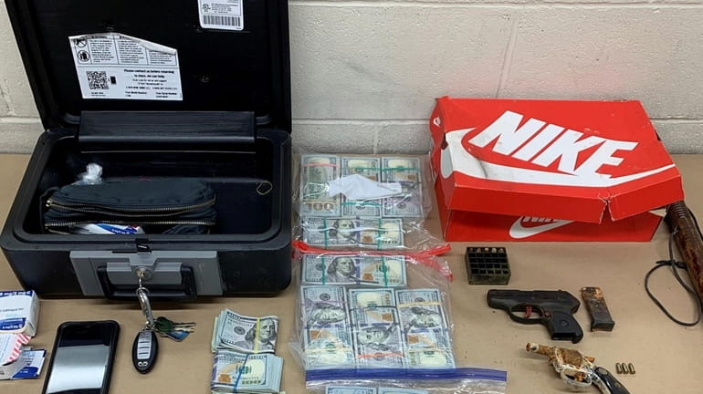 Cash, guns and other paraphernalia recovered after the arrest of...