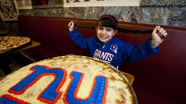 Giants fan Isabella Juliano, 6, of Blue Point, poses with...