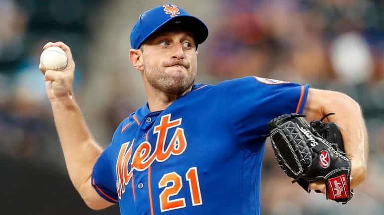 Max Scherzer of the Mets pitches during the first inning against...