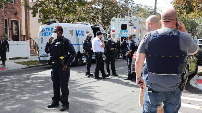 NYPD investigators at the scene in Queens Thursday where authorities...