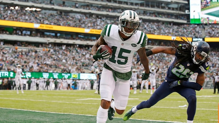 New York Jets wide receiver Brandon Marshall scores a touchdown...