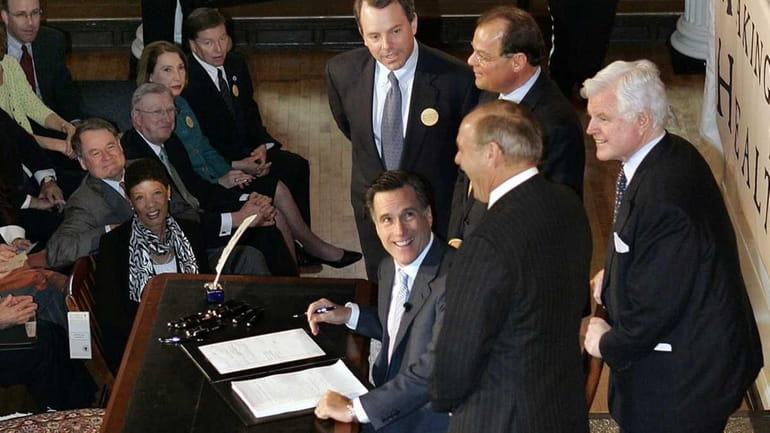 As governor of Massachusetts, Mitt Romney, seated, signs a law...