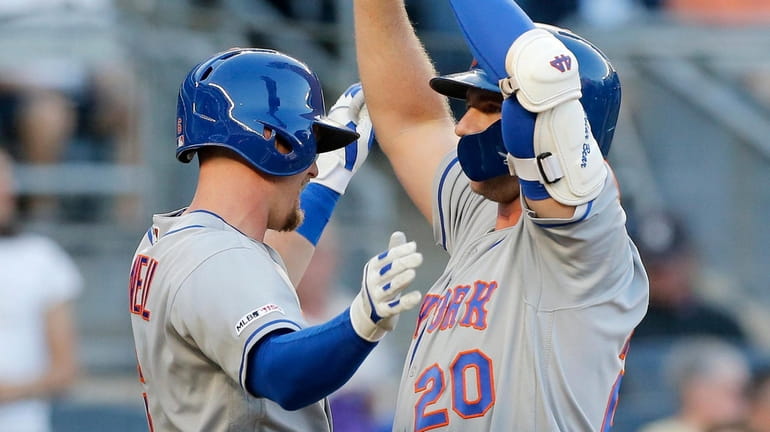 Pete Alonso of the Mets celebrates his first-inning, three-run home run...