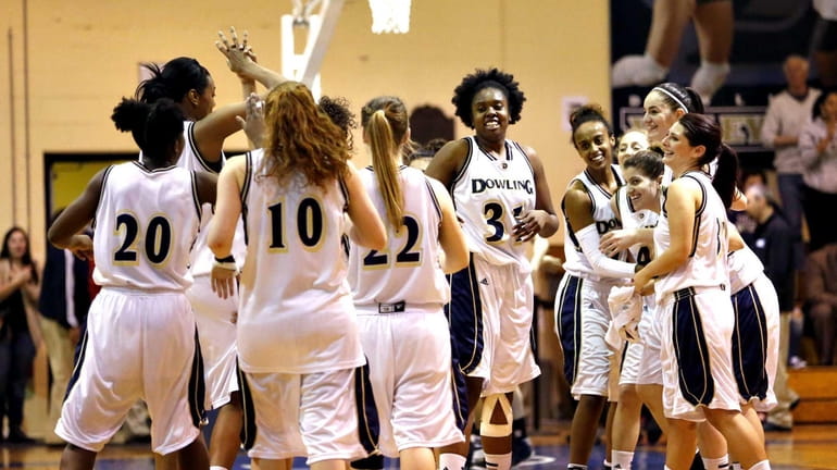 The Dowling women's basketball team celebrates its victory over NYIT...