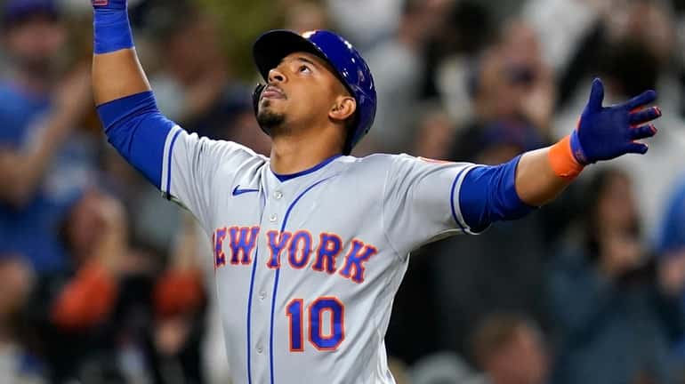 The Mets' Eduardo Escobar reacts after hitting a two-run home...