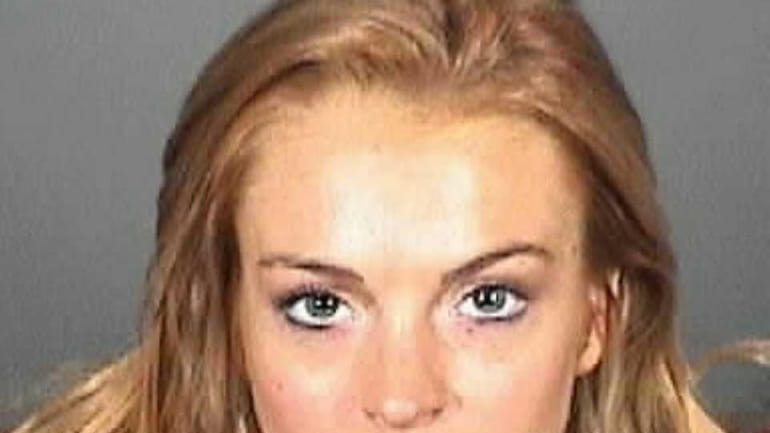 Lindsay Lohan appears in a booking photo after she was...
