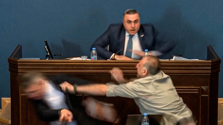 This photo taken from video released by Georgian Parliament on...