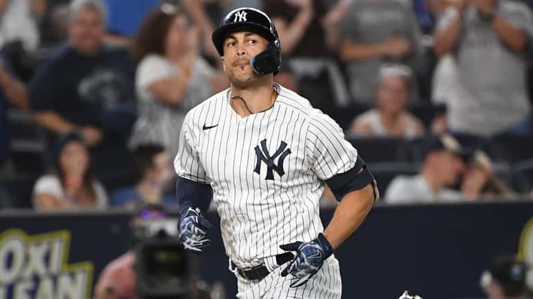 The Yankees' Giancarlo Stanton runs home on his solo home...