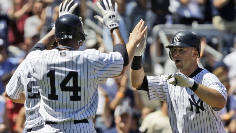 New York Yankees' Brett Gardner, right, celebrates with teammates Curtis...