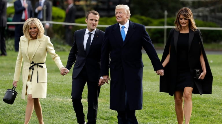 President Donald Trump and first lady Melania Trump walk on...