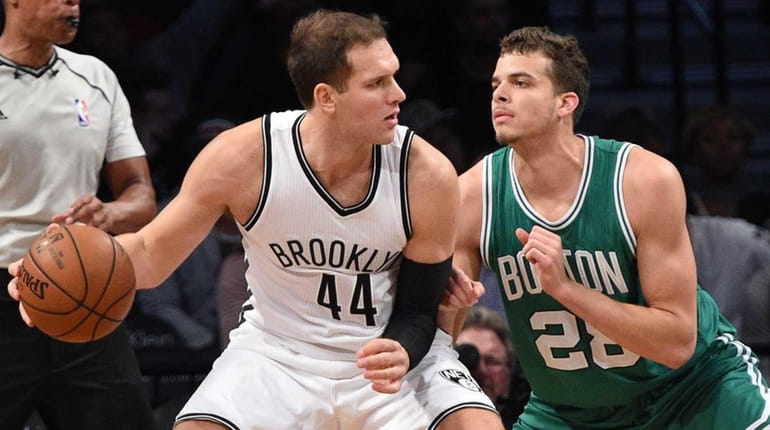 Brooklyn Nets guard Bojan Bogdanovic is defended by Boston Celtics...