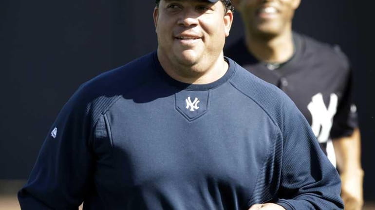 New York Yankees pitcher Bartolo Colon runs in the outfield...