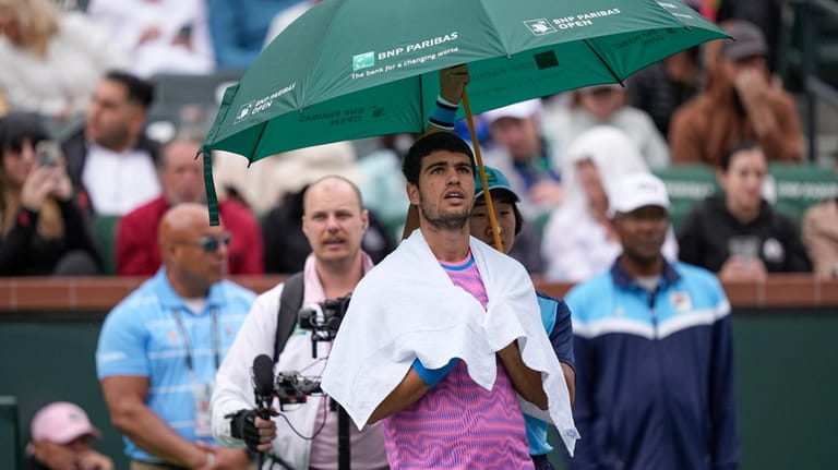 Carlos Alcaraz, of Spain, looks on during a rain delay...