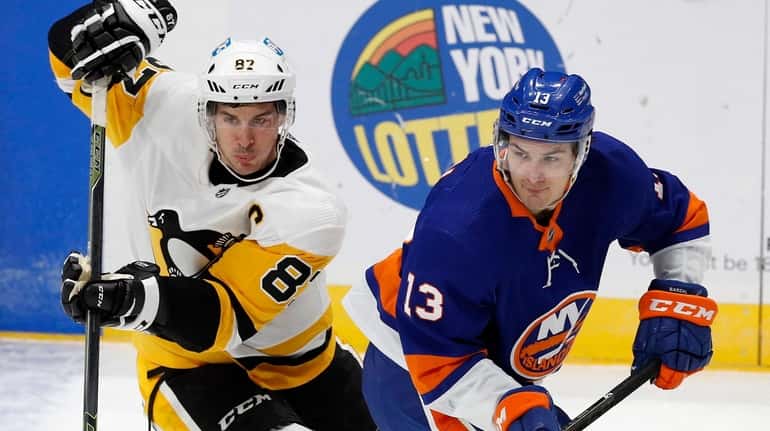 Mathew Barzal of the New York Islanders skates against Sidney...