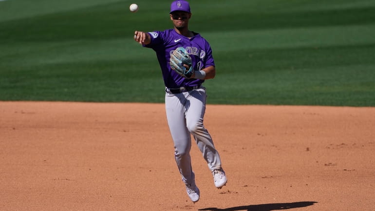 Colorado Rockies' Ezequiel Tovar fields a ground out hit by...