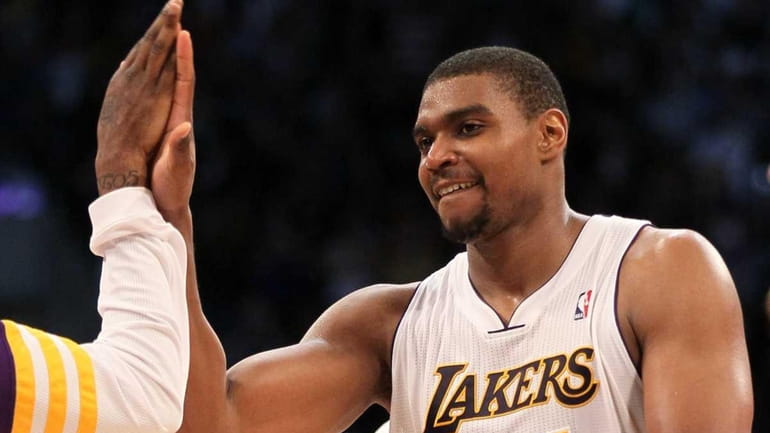 Andrew Bynum #17 of the Los Angeles Lakers celebrates after...