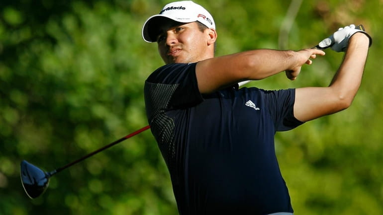 Jason Day of Australia watches his tee shot on the...