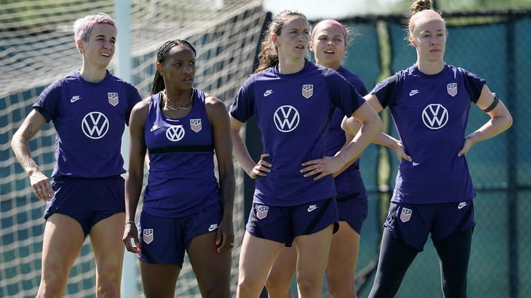 U.S. national team player Crystal Dunn, second from left, listens...