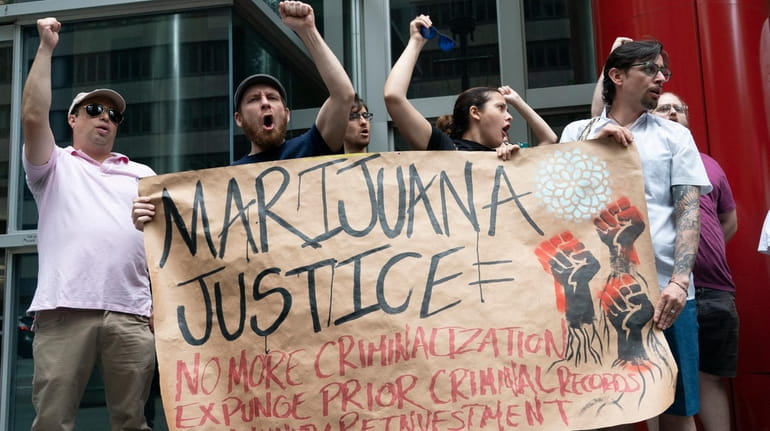 Marijuana legalization supporters rally on Sunday outside of Gov. Andrew M....
