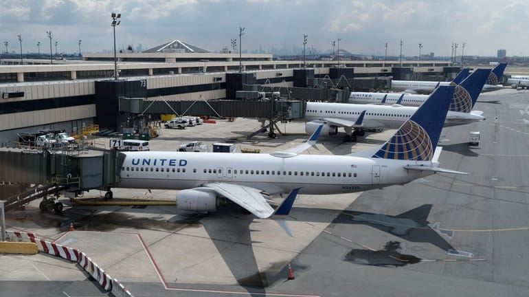 Planes are parked at gates at Newark Liberty International Airport...