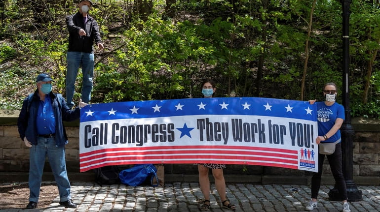 Members of Indivisible Brooklyn demonstrate May 2 outside Sen. Chuck...