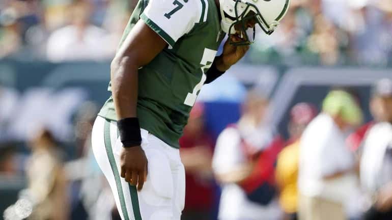 Geno Smith #7 of the Jets stands on the field...