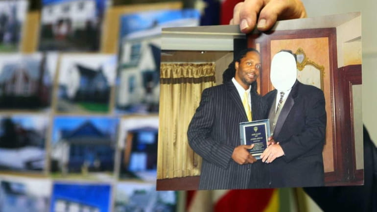 Detective Lt. Raymond Cote holds a photo of Jamel Smith,...