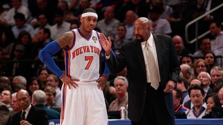 Mike Woodson, right, talks with Carmelo Anthony during a game...