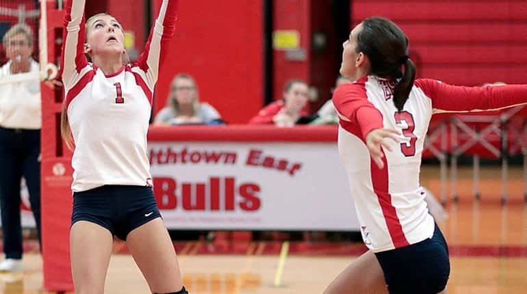 Smithtown East's Brooke Berroyer (1) sets the ball for Paige...