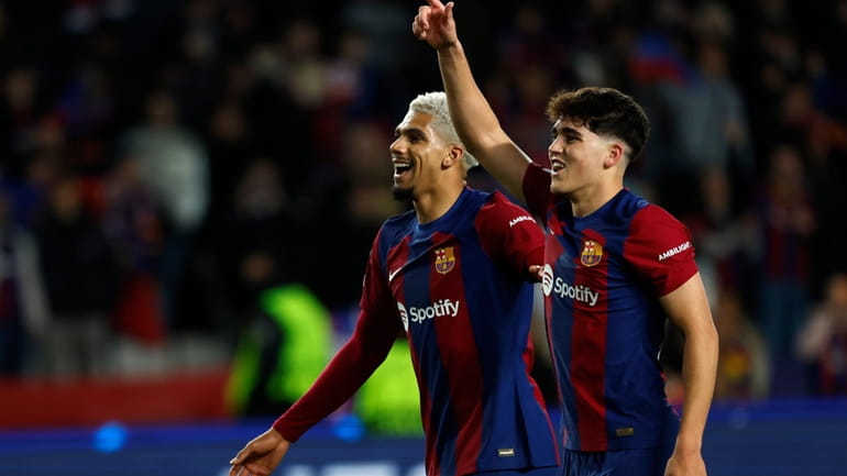 Barcelona's Pau Cubarsi, right, and Barcelona's Ronald Araujo celebrate after...