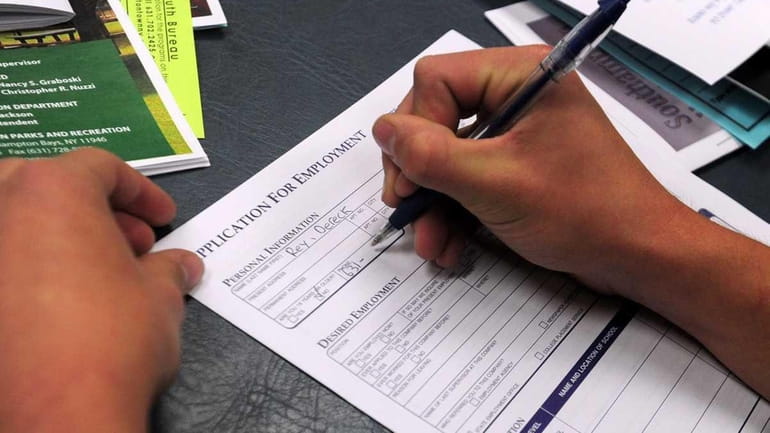 Teens fill out job applications as they look for jobs...