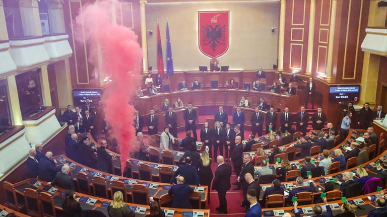 Lawmakers of Democratic Party light a flare inside the Parliament...