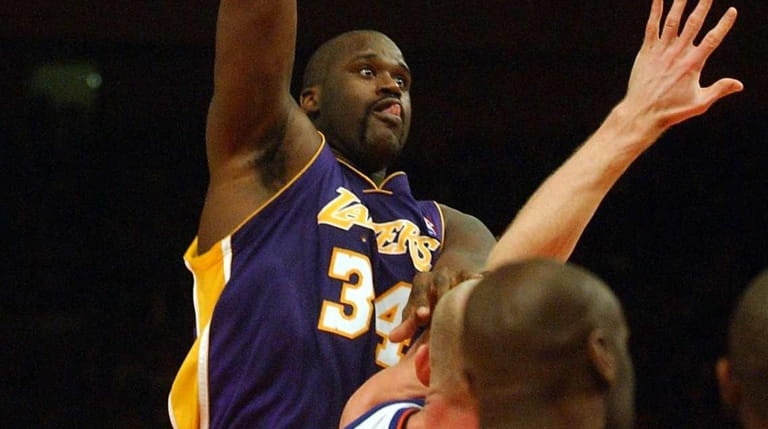 The Lakers' Shaquille O'Neal goes in for the dunk againast...