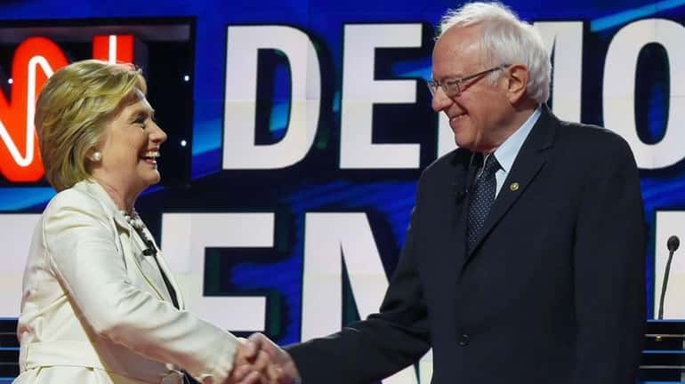 Democratic presidential candidates Hillary Clinton and Bernie Sanders shake hands...