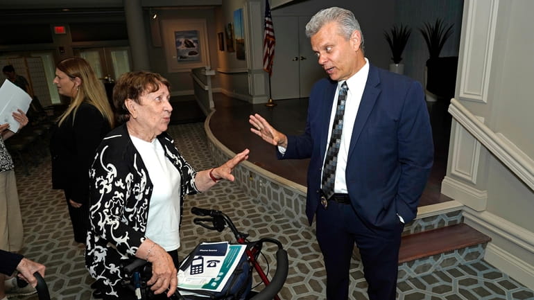 Marion Salgado chats with Suffolk County Police Department Det. Thomas...