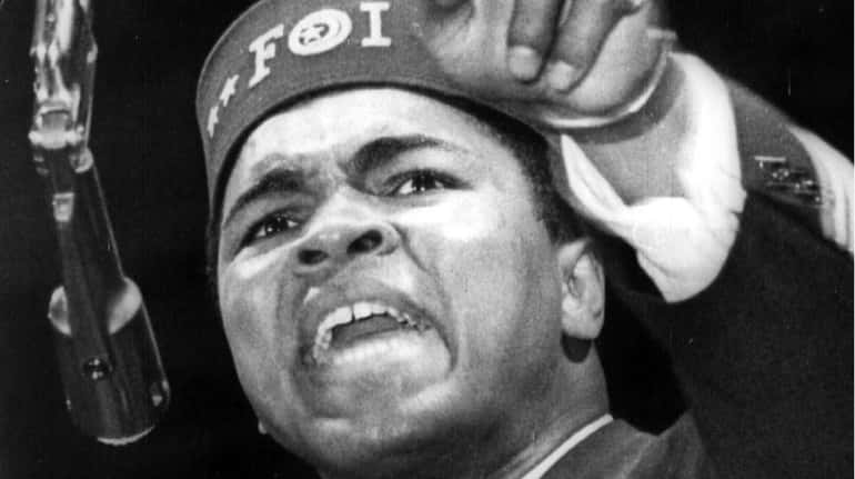 Muhammad Ali addresses a gathering at a Black Muslim convention...