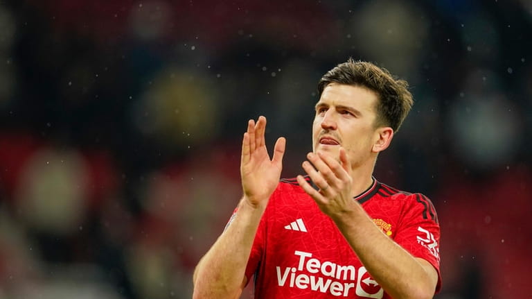 Manchester United's Harry Maguire applauds at the end of the...