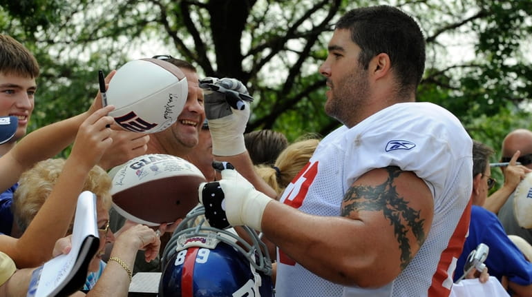Giants offensive lineman Shane Olivea, of Cedarhurst, signs autographs after the...
