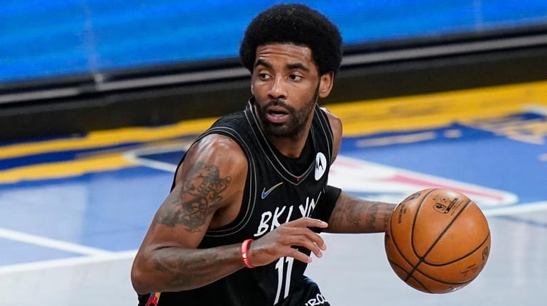 Brooklyn Nets' Kyrie Irving moves the ball during the first...
