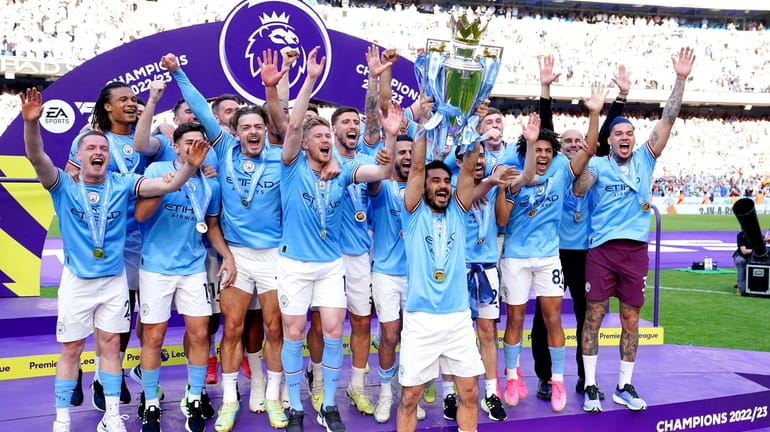 Manchester City's Ilkay Gundogan lifts the Premier League trophy after...