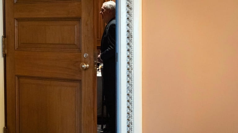 Senate Minority Leader Mitch McConnell of Ky., is seen through...