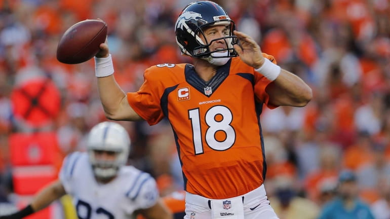 Denver Broncos quarterback Peyton Manning (18) throws against the Indianapolis...