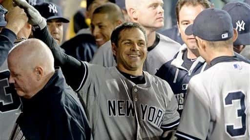Brian Roberts is greeted in the dugout after hitting a...