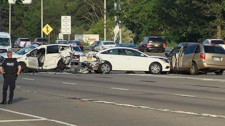Police at the scene of a three-vehicle crash that shut...