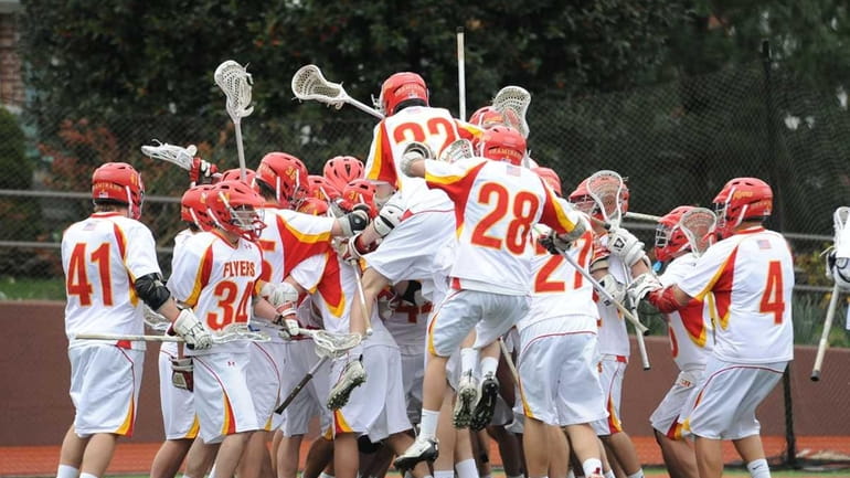 Chaminade teammates celebrate after beating West Islip 7-6 on Matthew...
