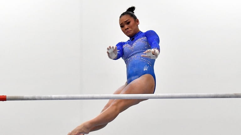 Sunisa Lee performs on the uneven bars at the USA...