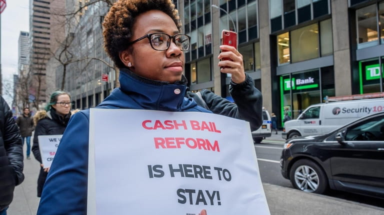 A woman holds a protest sign in Manhattan in January 2020.