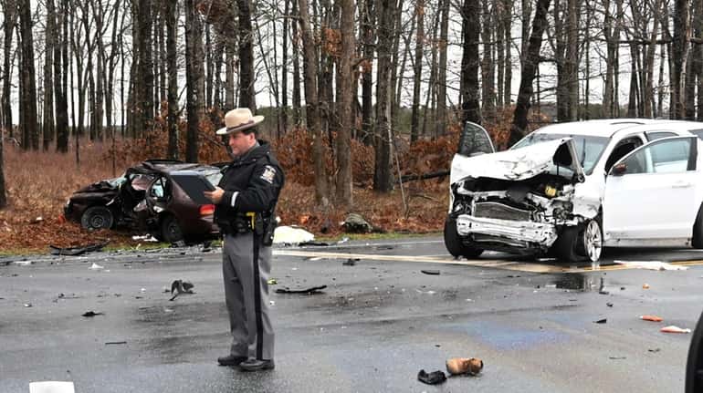 Police investigate a two-vehicle collision at Middle Country Road and Burman Boulevard in...